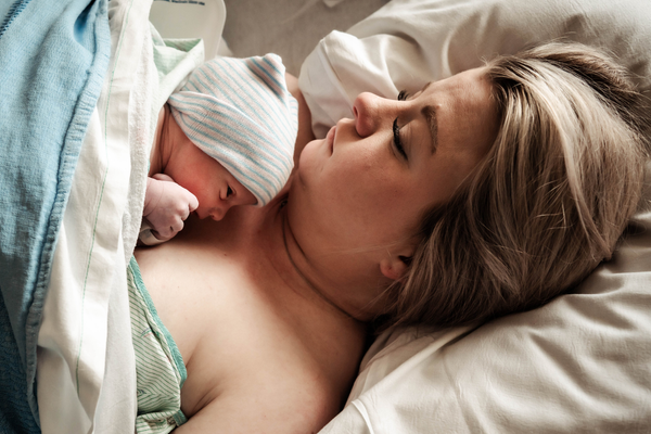 Birth support — a doula holding hands with a laboring mother
