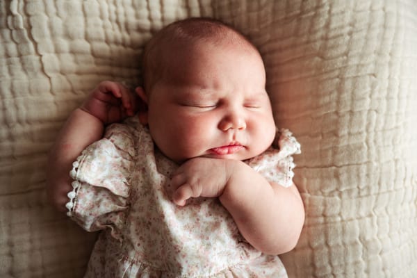 Postpartum support — a mother tenderly holding her newborn